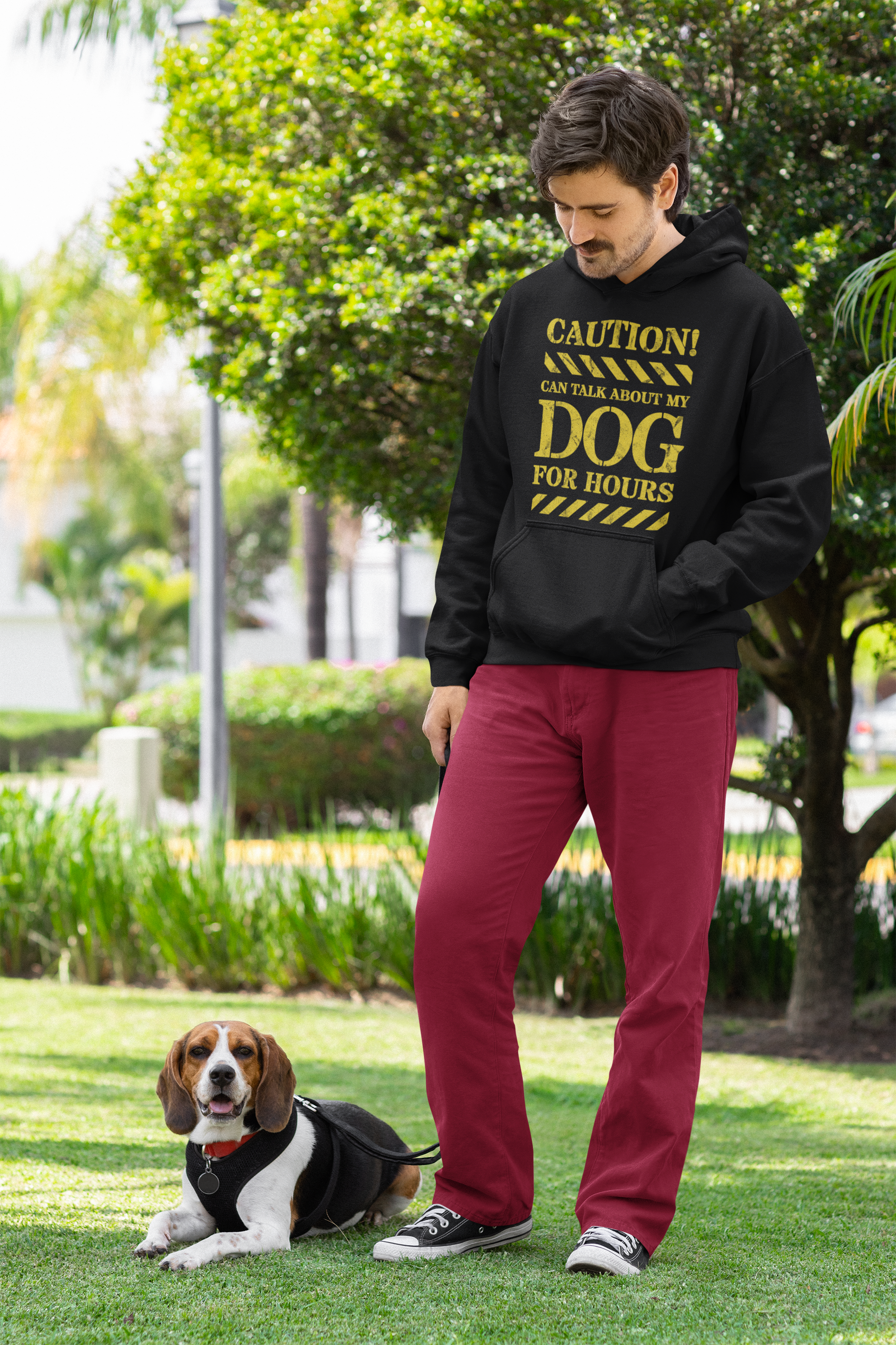 Man wearing black hoodie posing with his cute dog