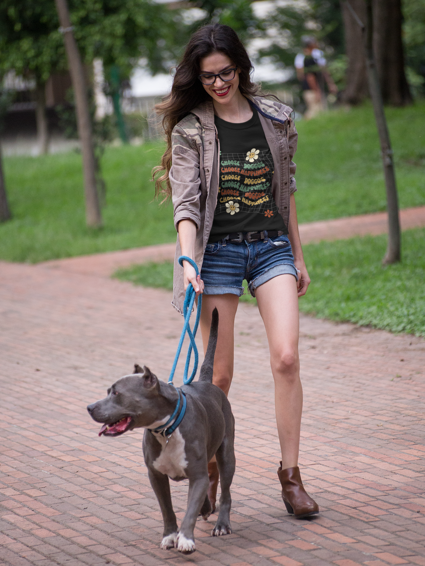 Dog mom wearing t-shirt that says choose doggos choose happiness walking her dog