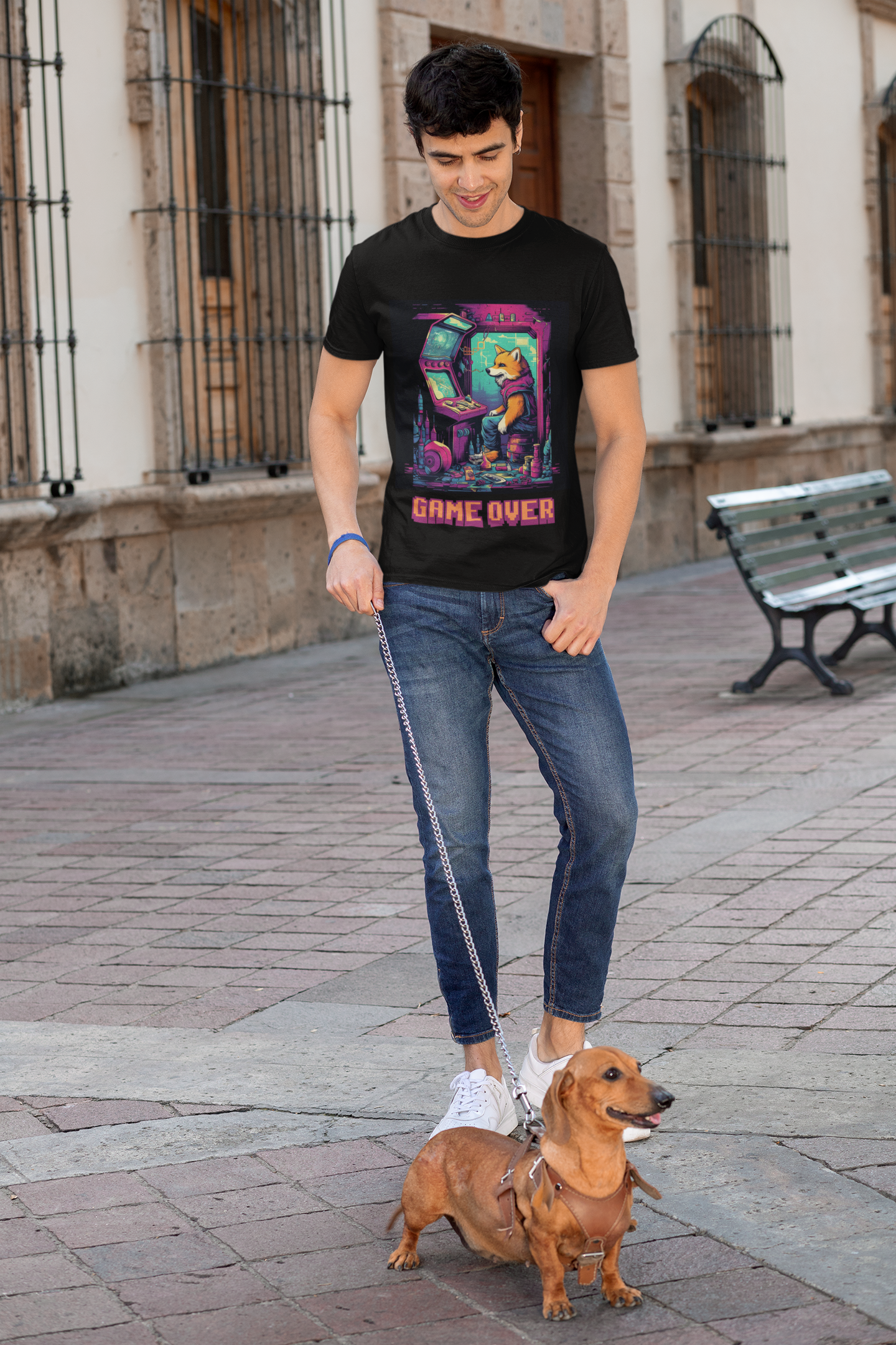 Guy walking his dog wearing Game over t-shirt with graphic of a dog playing retro arcade games